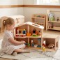 Preview: Kind spielt mit Puppenhaus Garage aus massivem, naturbelassenem Holz mit Auffahrtsrampe.