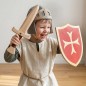 Preview: Lachendes Kind spielt Ritter mit Holzschwert und Holzschild aus Holz im Kinderzimmer