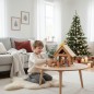 Preview: Kind spielt mit der Weihnachtskrippe und den Figuren und Tieren aus massivem Holz in der Wohnung