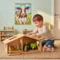 Preview: Natürliches Holz Puppenhaus als Bauernhof. Kind spielt konzentriert im warmen, skandinavischen Zimmer.
