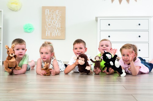 Kinder spielen mit verschiedenen Handpuppen-Tieren vom Kanguruh, über Affen, bis hin zu einer Katze. Alle Tiele haben noch jeweils ein Jungtier.